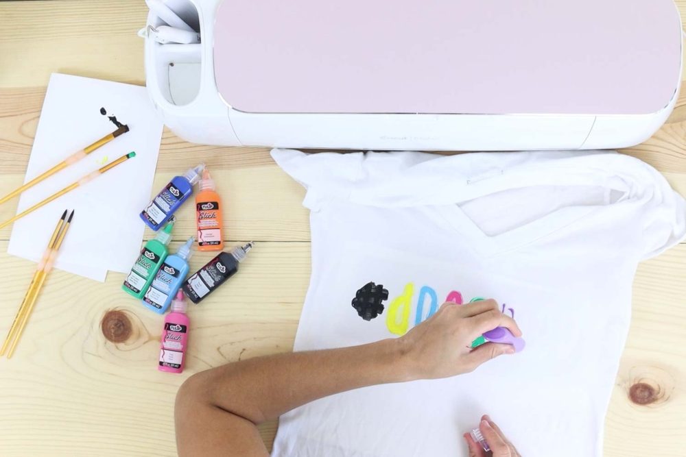 Painting a t-shirt with different colors using the freezer paper stencil method.