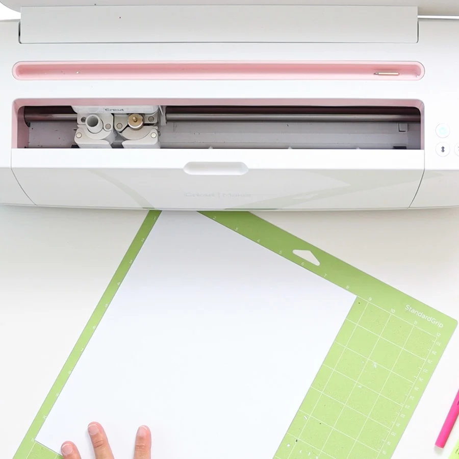 placing copy paper on cricut mat