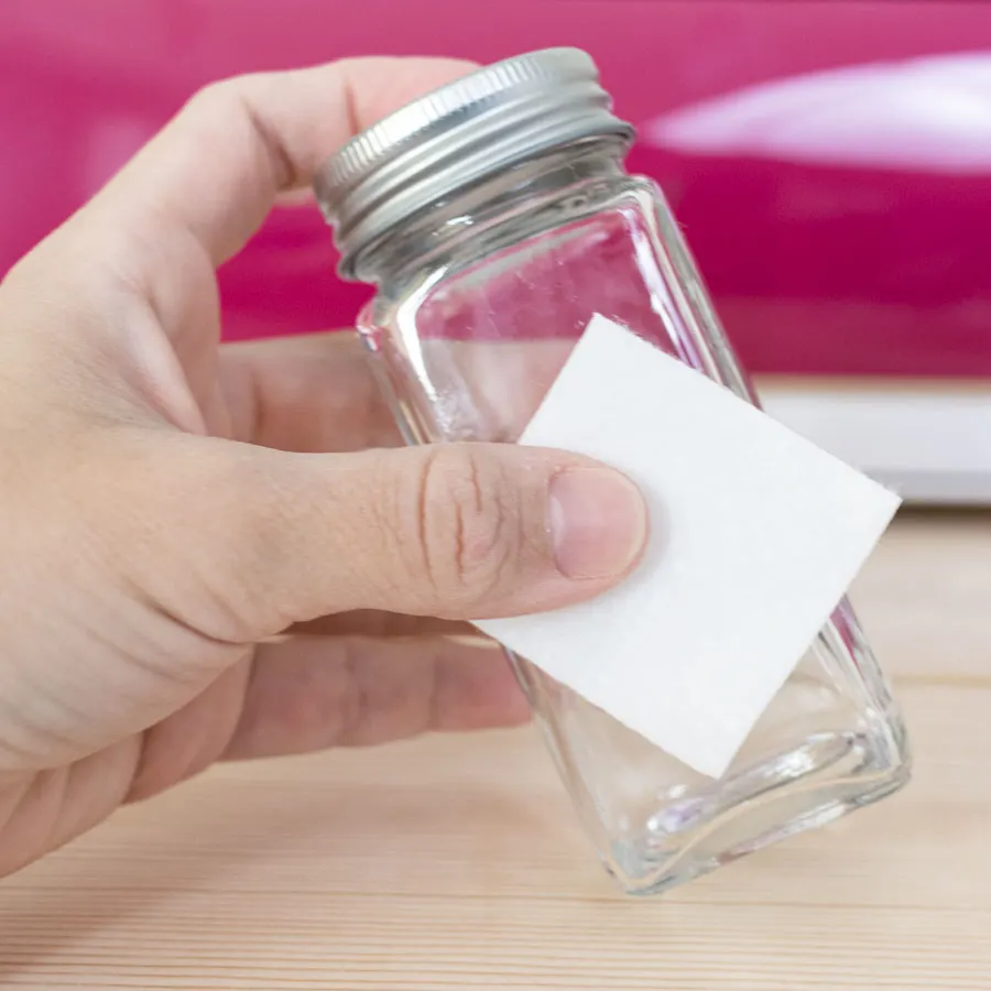 wiping spice jar with alcohol.