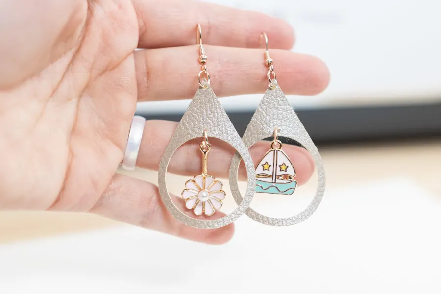 tear drop earrings made with cricut and charms.