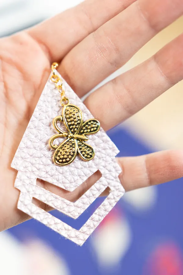 triangle and butterfly earring made with cricut