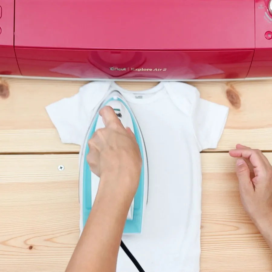 pressing onesie to get rid of moisture, wrinkles