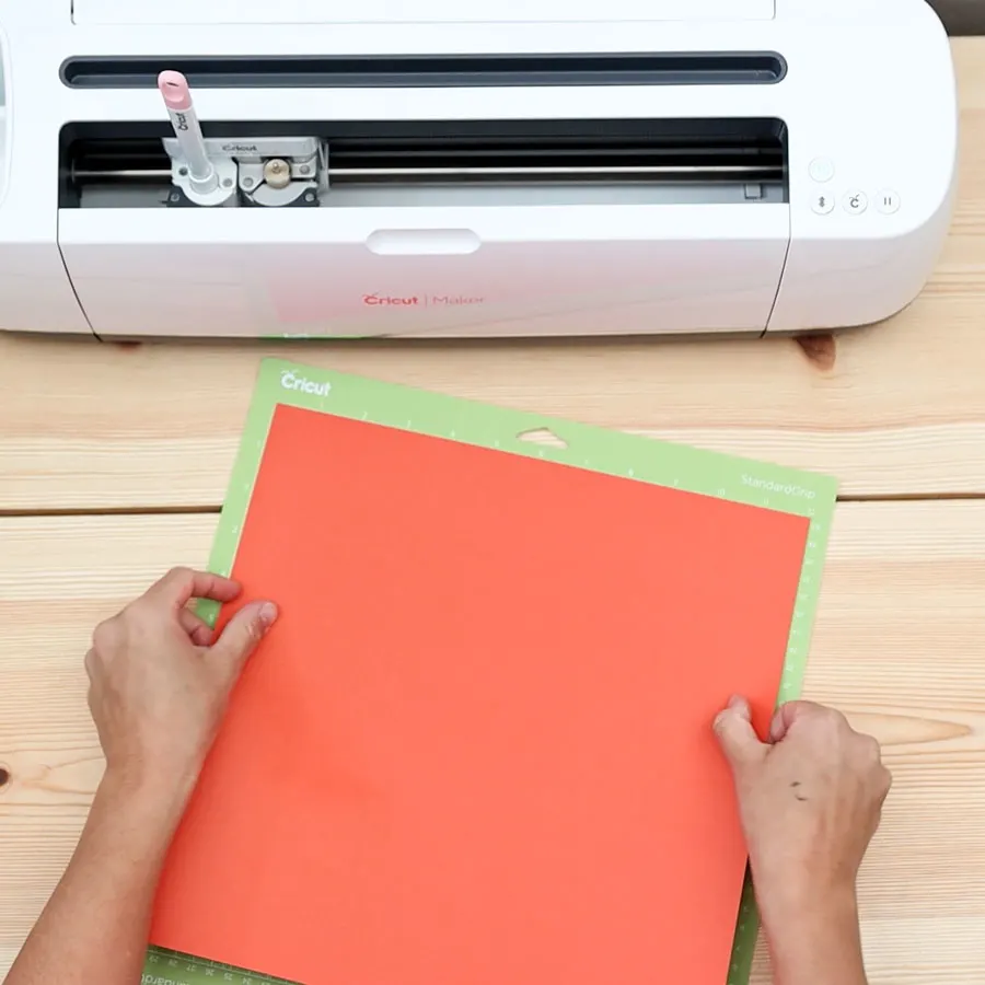 placing red cardstock on cricut mat