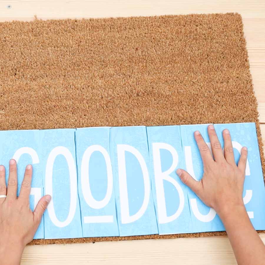 placing stencil vinyl on doormat