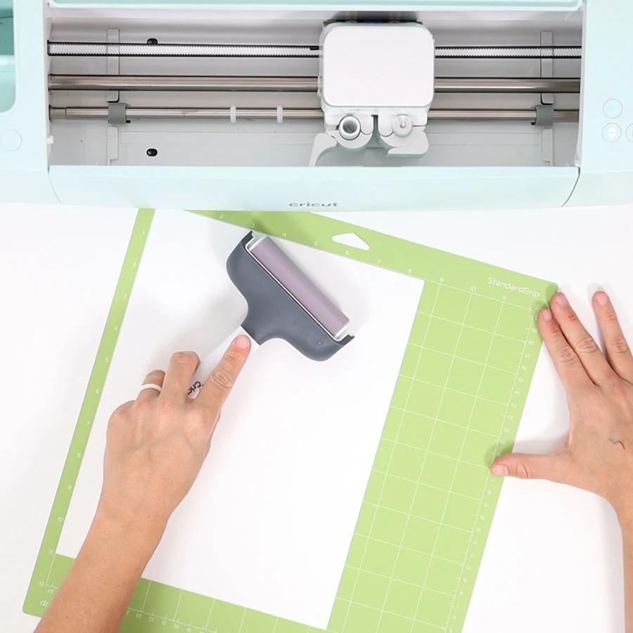 placing white cardstock on cricut mat