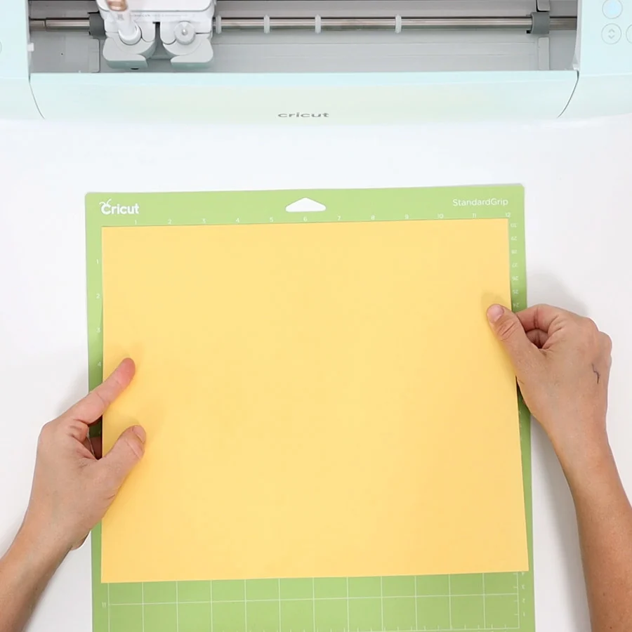 placing yellow cardstock on mat