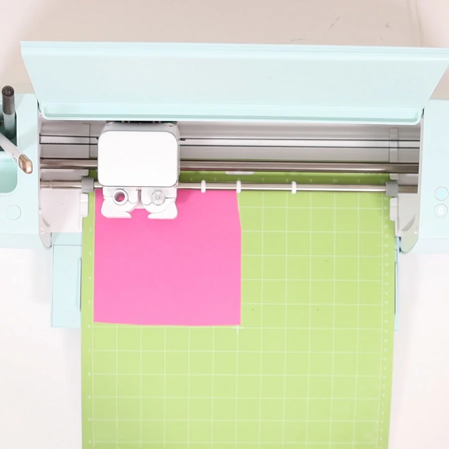 loading pink cardstock to cricut machine