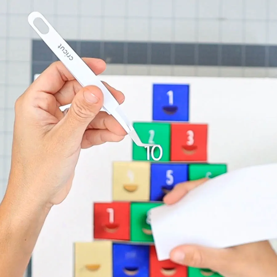 removing number from sticky cardstock with tweezer.