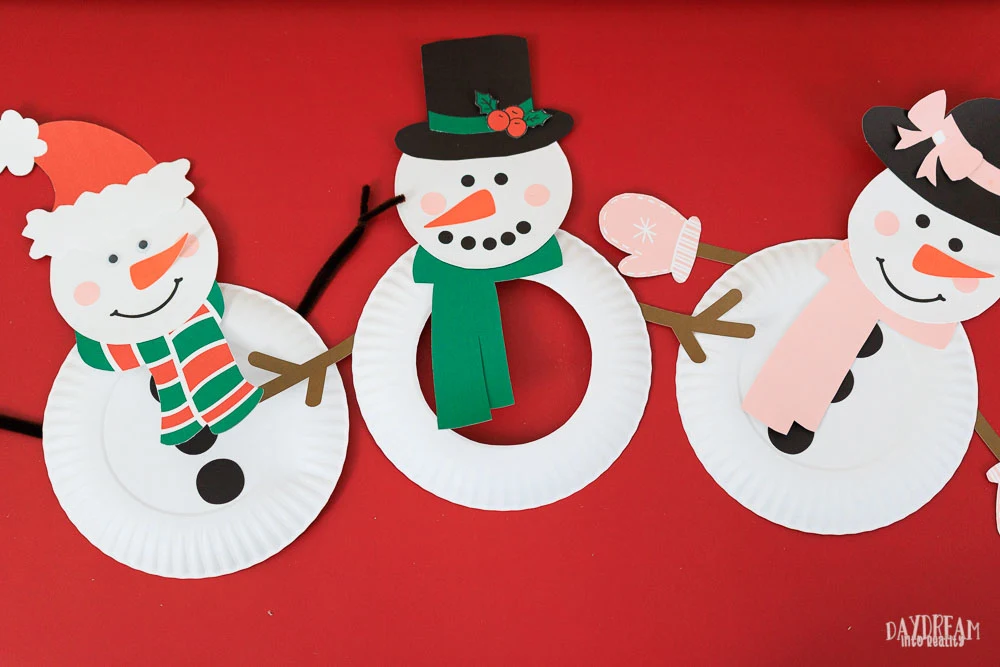 paper plate snowman craft. Santa hat, hat with holly decoration and snowwoman