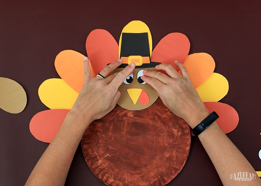 glue hat on paper plate turkey craft.