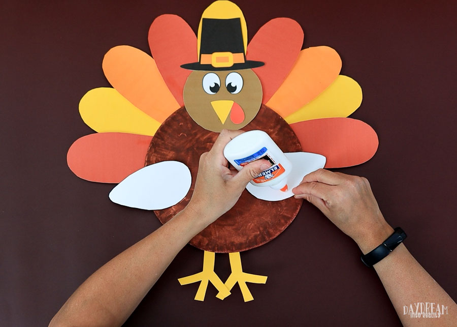 glue wings on paper plate turkey craft.