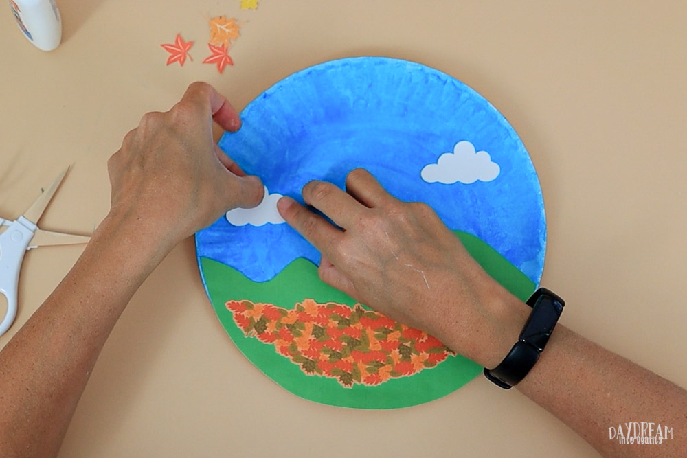 glue clouds to paper plate