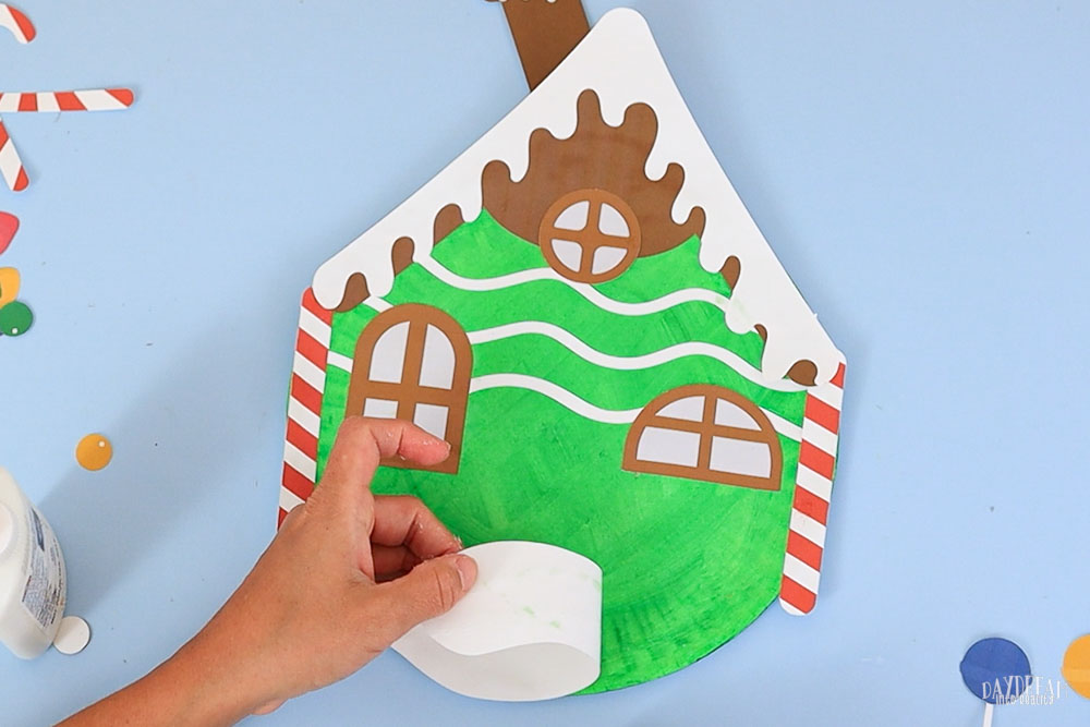 gluing snow on paper plate