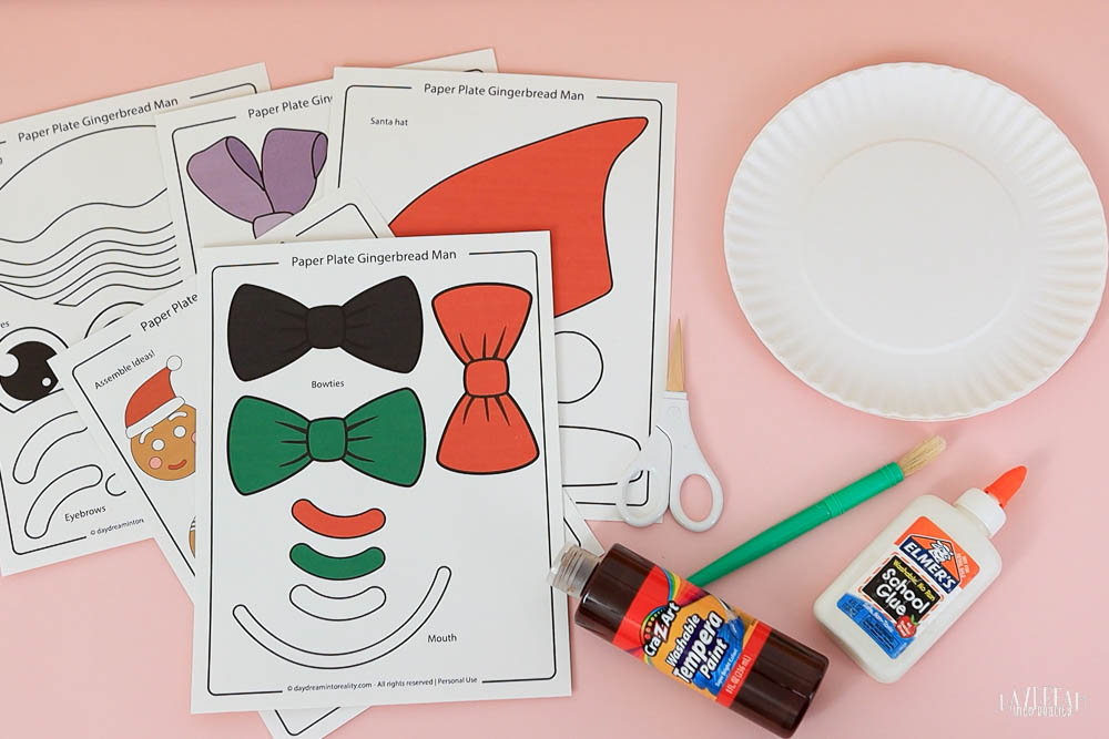 materials for making a gingerbread man craft for kids using paper plates