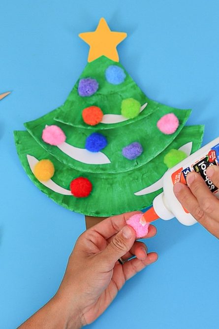 glue pom poms to Christmas tree paper plate craft