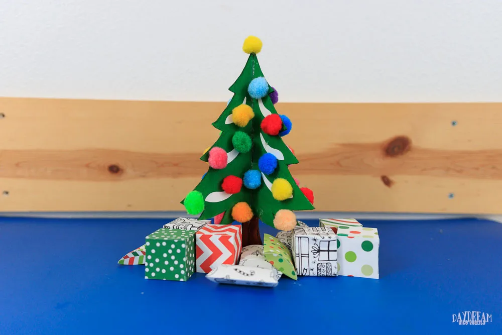 Cardboard Christmas Tree Craft Kids - With pom poms as ornaments and mini gift boxes.